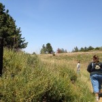 Denise and AJ pass a rusting barbwire fence on the trail. 