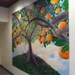 A painting of orange trees inside the new Marcy Branch Library.