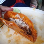 A look inside a taco dorado with birria (goat meat).